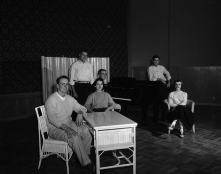 Students sit together with a piano.