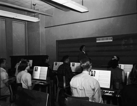 Students practicing piano in class.