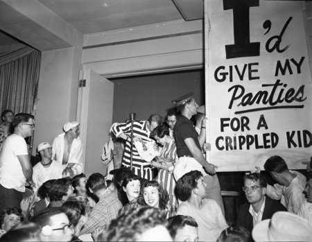 Students hold a panty raid with signs that read: "I'd give my panties for a crippled kid".