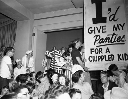 Students hold a panty raid with signs that read: "I'd give my panties for a crippled kid".