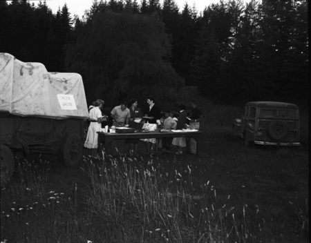 Students in a summer hiking class getting a meal at the chuck wagon.