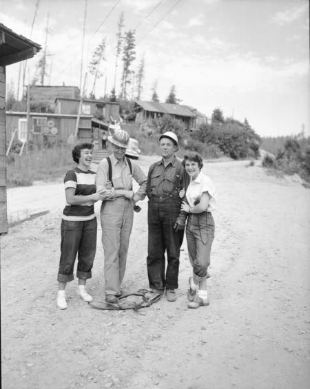 Students pose with loggers during their summer hiking class.