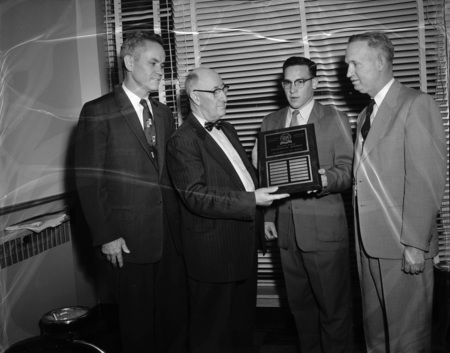 Left to right: Dean Don Marshall, D.L. Fourt, Phillip Edwards, and Dean Kraus receiving the Ralston Purina Company Award.