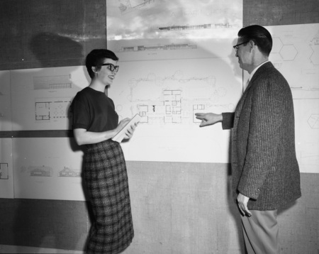Molly Godbold and Architecture Department Head Charles Bartal looking at architectural drawings.