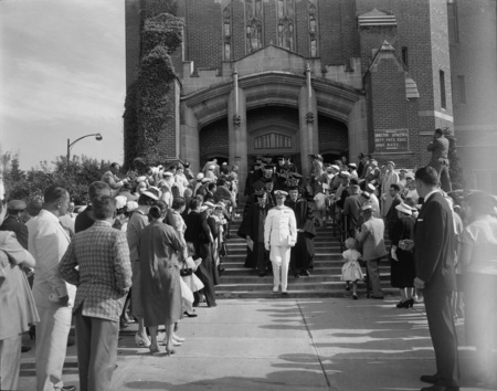 A line of Seniors on their way out of Commencement.