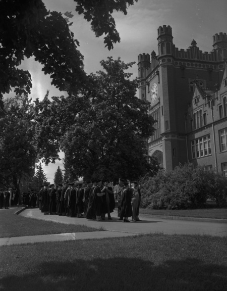 Students gather outside of the Administration Building on Commencement Day.