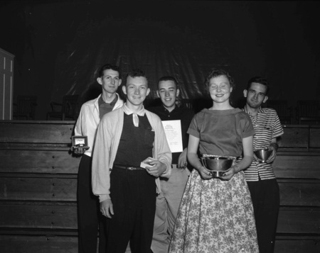 Seniors holding awards at commencement.