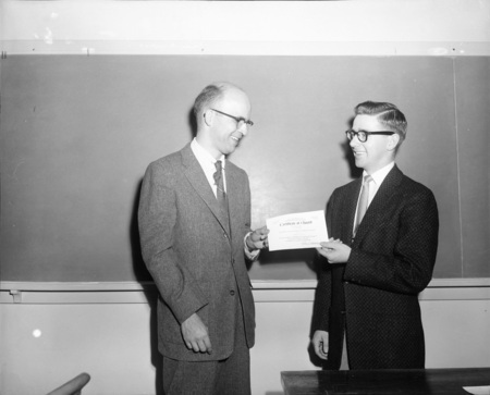 Student John Hughes receives Sigma Delta Chi award at commencement.