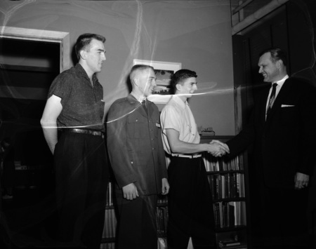 College of Education Ray Wilke (left) awards Howard T. Andrews as outstanding student, Dean Weltzin on the right.