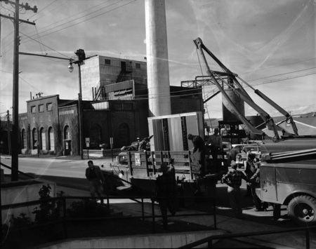 Unloading telephone switchboard donated by General Telephone Company.