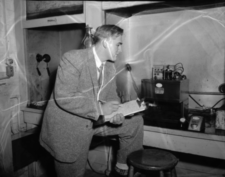 Francis E. Keller, Boise Petroleum scholar, checking viscometer in College of Engineering laboratory.
