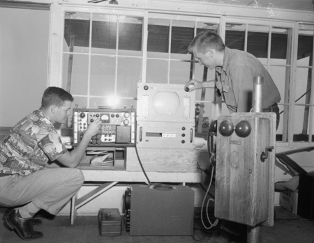 College of Forestry students adjust electronic equipment for fire detection demonstration.