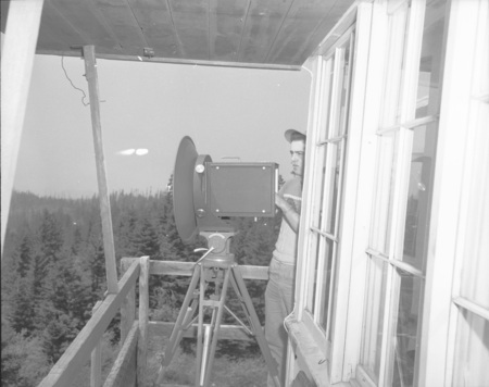 College of Forestry student operating microwave equipment at fire detection conference.