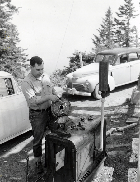 College of Forestry Lloyd B. Craine filling generator tank at fire detection conference.