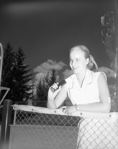 Tennis team member Sissel Andreason gets her portrait taken on the tennis court.