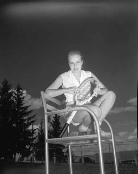 Tennis team member Sissel Andreason gets her portrait taken on the tennis court.