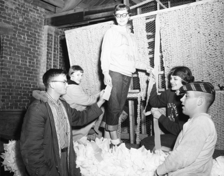 Students work together of the construction of the homecoming float.
