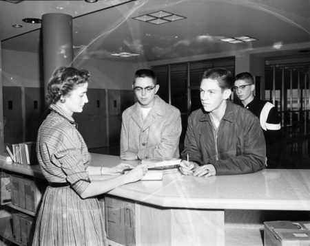 Students checking out books at the library.