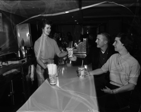 University of Idaho Homecoming Queen Marilyn Crane serving milkshakes to Ginger Symms and Robert Cowan.