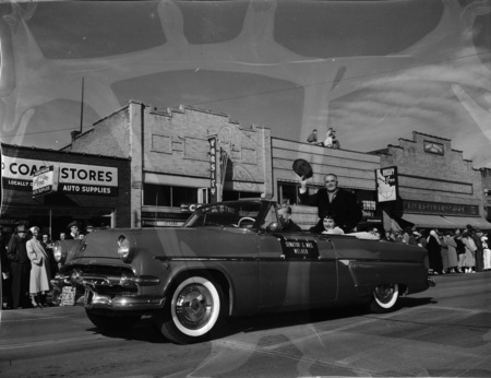 Idaho Senator Welker and his wife, Gladys Welker, in a automobile during the homecoming parade in downtown Moscow.