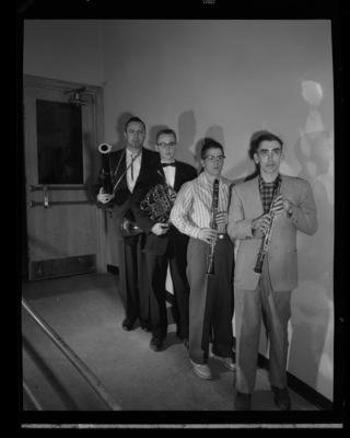 Warren Bellis (front), University of Idaho director of band, stands in line with several soloists for a concert.