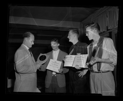 High school students holding their awards from a journalism conference.