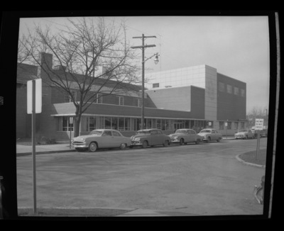 A photograph of the outside of University of Idaho's Student Union Building, automobiles line the road out front.