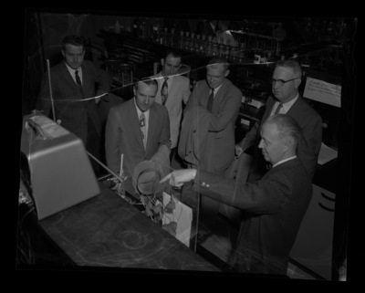 Dr. James Jordon speaking to Idaho Academy of Science members (l-r): Charles Swensen, Dr. D.J. Obee, Danny Warfield, W.J. Smallwood, and Dr. James Kraus in a laboratory.