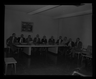 The land grant directors sitting around a table.