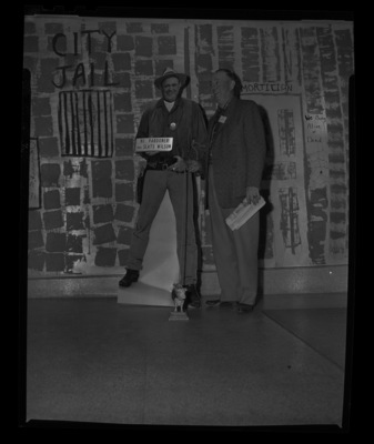 President of the Idaho Cattlemen's Association Slats Wilson poses with a life sized cut out of him greeting the ICA members in a sherrif's outfit.