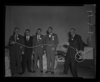 A group photograph of (l-r) ICA Secretary Leon L. Weeks, Governer Robert E. Smiley, unidentified, unidentified, and ICA President Slats Wilson at the ICA Chuckwagon Dinner at the Elk's Club in Downtown Moscow.