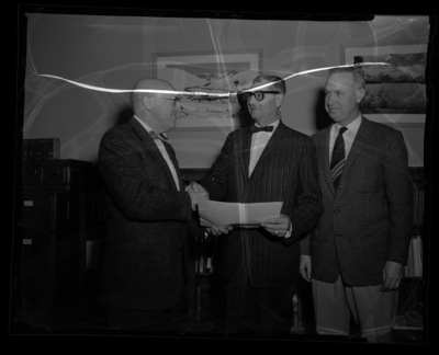 University of Idaho President Theophilus and Dean of Agriculture James E. Kraus awarding certificate for outstanding service to Associate Director of Extension, Carol O. Youngstrom.