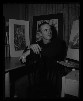 University of Idaho Art student Iain Baxter showing his artwork while painting.