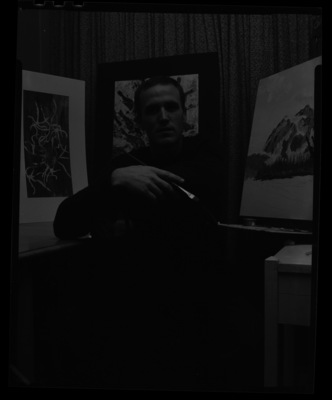 University of Idaho Art student Iain Baxter showing his artwork while painting.