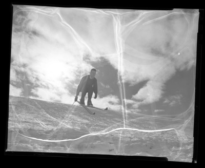 University of Idaho ski team member Chuck Rank mid-jump on skis.