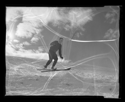 University of Idaho ski team member Chuck Rank mid-jump on skis.