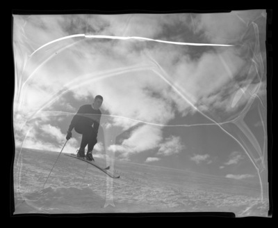 University of Idaho ski team member Chuck Rank mid-jump on skis.