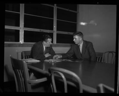 College of Business Administration applicant Per Windju and campus representative looking over some documents.