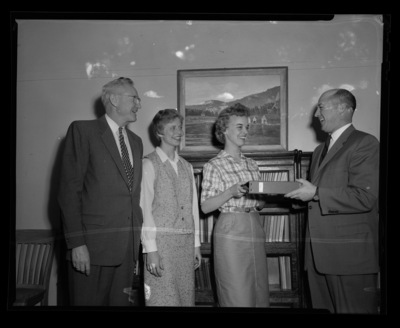 Bob Kessel and Dean of the College of Education J. Fredrick Weltzin presenting award to Fran Baudek (l) and Shirley Henriksson (r) .