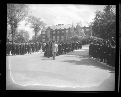 The Academic Parade leads the traditional commencement walk from the Administration Building to Memorial Gym.