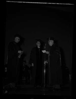 Dr. Lawrence Chamberlain receives an honorary Doctor of Laws degree from University of Idaho President Donald Theophilus at the commencement ceremony. Dr. Boyd A. Martin, Dean of Letters and Science, on left.