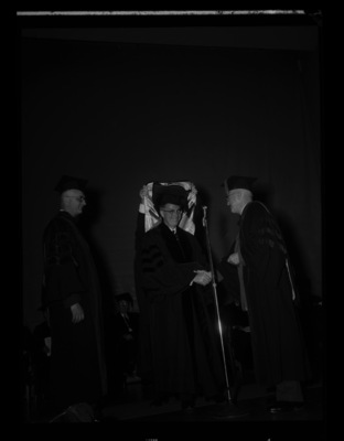 Dr. Lawrence Chamberlain receives an honorary Doctor of Laws degree from University of Idaho President Donald Theophilus at the commencement ceremony. Dr. Boyd A. Martin, Dean of Letters and Science, on left.
