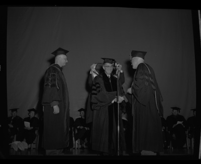 Dr. Lawrence Chamberlain receives an honorary Doctor of Laws degree from University of Idaho President Donald Theophilus at the commencement ceremony. Dr. Boyd A. Martin, Dean of Letters and Science, on left.