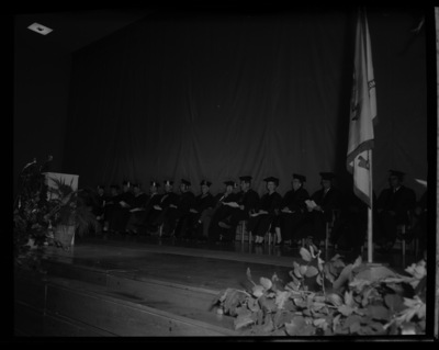 President Theophilis, Governor Smylie, and keynote speaker Inez Callaway Robb sit with College Deans and faculty on stage during commencement.