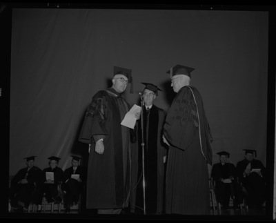 Dr. Lawrence Chamberlain receives an honorary Doctor of Laws degree from University of Idaho President Donald Theophilus at the commencement ceremony. Dr. Boyd A. Martin, Dean of Letters and Science, on left.