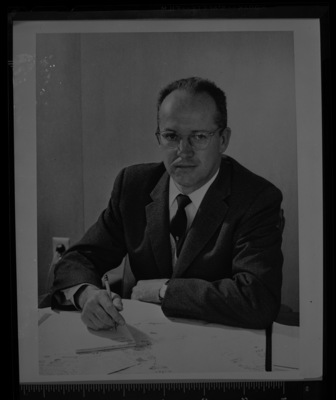 A man sits at a desk