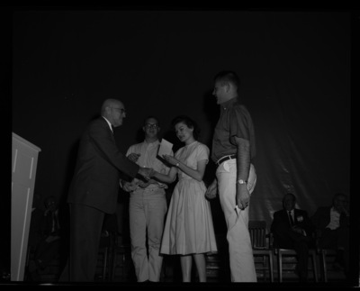 President Theophilus gives the Attic Club Art Prizes to (l-r) Ronald Goodwin, Sandra Summerfield, and George Bertonneau at the 1960 May Fete.