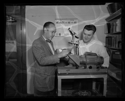 Mr. Paul Kaus showing a Keystone Overhead Projector to an Audio-Visual Aids student.