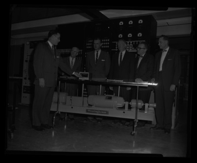 Westinghouse presentation being given to engineering faculty (l-r) H. Walter Steffans, Dean Alan S. Janssen, Electrical Engineering professor Hubert E. Hattrup, unidentified, unidentified.