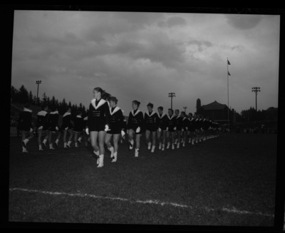 The Vandalettes march on the field at Neale Stadium for the Homecoming game. Memorial Gym can be seen in the background.